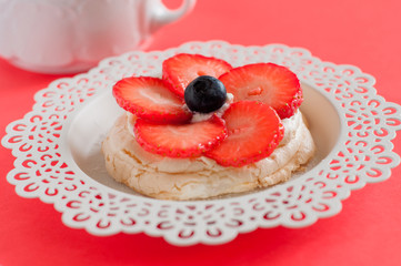 Anna Pavlova cake with strawberries, blueberries and cream cheese