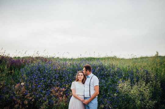 Happy Bride and groom walking on the green grass