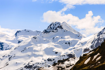 Fototapeta na wymiar Snow-capped mountains on a blue sky background
