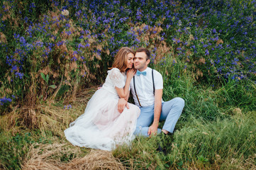 Happy Bride and groom walking on the green grass