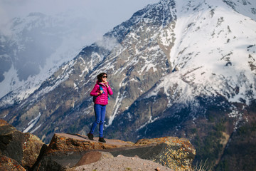 Fototapeta na wymiar Active tourist woman enjoying the view. The Caucasus