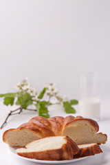 White bread and a glass of milk on white background