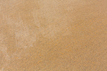 Fototapeta na wymiar Wet yellow sand background.