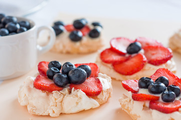 Anna Pavlova cake with strawberries, blueberries and cream cheese
