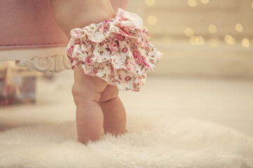 Kid baby girl in pink clothes and happy interior