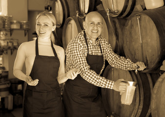 Fototapeta na wymiar Portrait of two adult happy wine makers