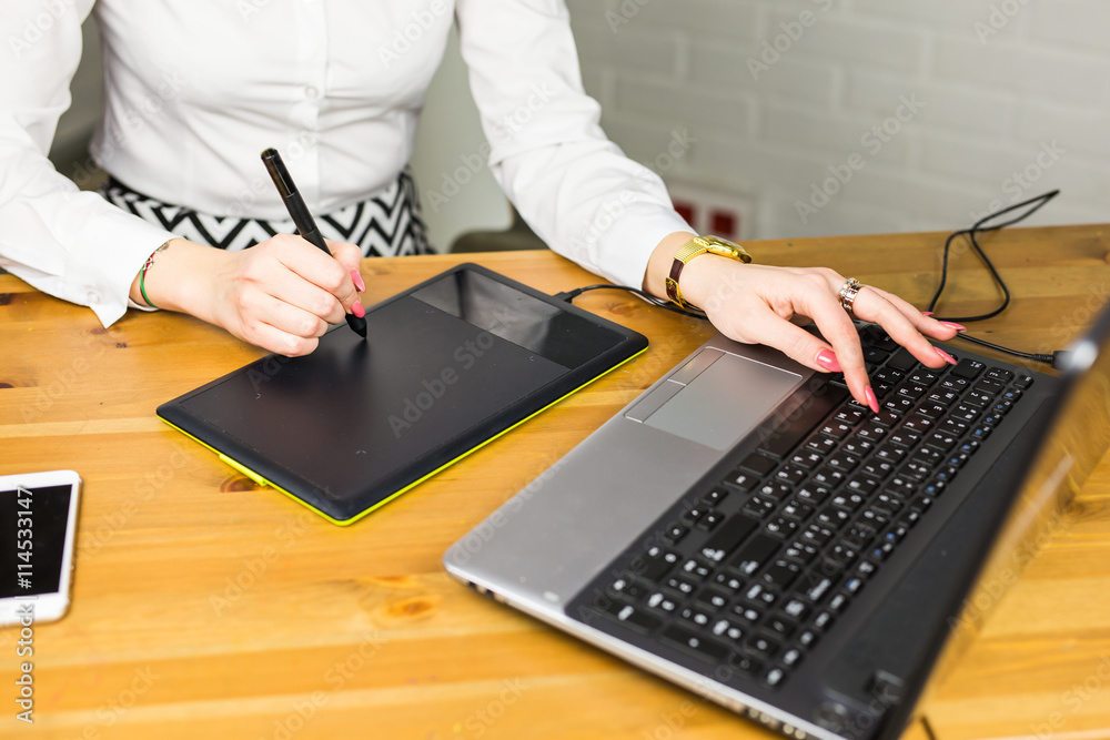 Fototapete Close-up of designer using graphics tablet while working with computer