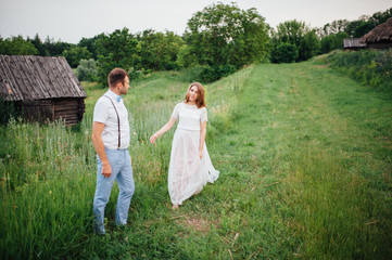 Fototapeta premium Happy Bride and groom walking on the green grass