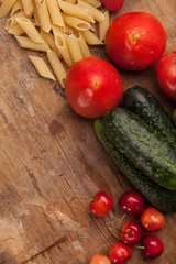 Italian food ingredients on flat wooden background