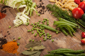 Vegetables and pasta on wood background. Bio Healthy food, herbs and spices. Organic vegetables