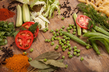 Vegetables and pasta on wood background. Bio Healthy food, herbs and spices. Organic vegetables