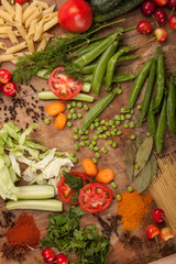 Vegetables and pasta on wood background. Bio Healthy food, herbs and spices. Organic vegetables