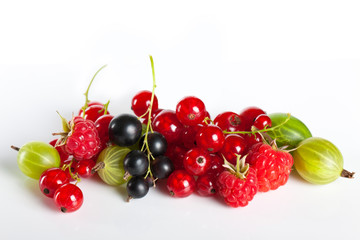 Ripe juicy berries. Fruit Mix. Currants and gooseberries raspberries on a white background.