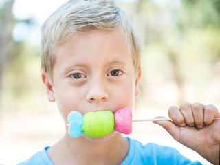 Cute kid eating marshmallows.