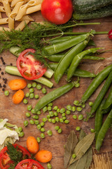 Vegetables and pasta on wood background. Bio Healthy food, herbs and spices. Organic vegetables