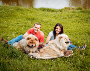 Young couple with the dogs in the park.