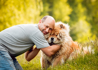 Adult man with the dogs in the park.