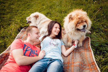 Young couple with the dogs in the park.