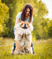 Young woman with the dogs in the park.