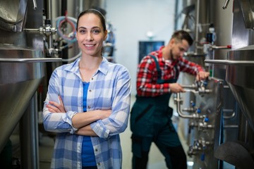 Fototapeta na wymiar Female maintenance worker standing at brewery