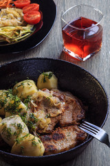 Home-cooked food. Roast pork and boiled potatoes with dill. Vegetable side dish and a drink.