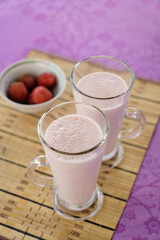 Milkshake with strawberries in a glass