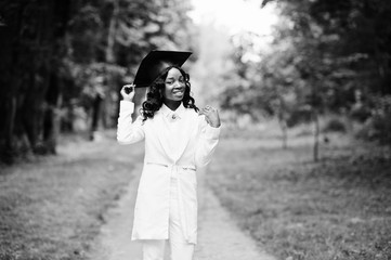 Happy beautiful black african american girl with hat graduates