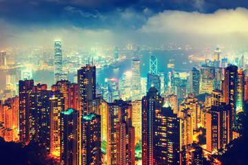 Scenic view over Hong-Kong, China, by night. Nighttime skyline with illuminated skyscrapers seen from Victoria Peak.