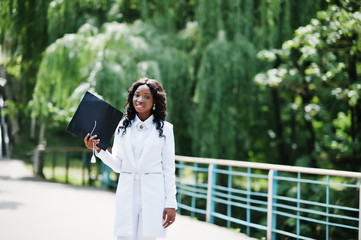 Happy beautiful black african american girl with hat graduates