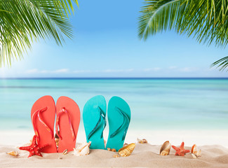 Summer flipflops on sandy beach
