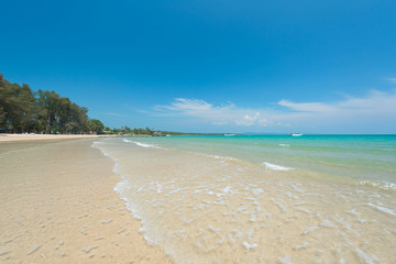 Beautiful water splash at the exotic beach with blue sky