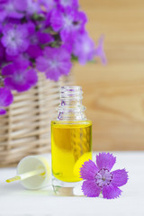 Fototapeta na wymiar Small bottle of natural cosmetic (essential) aroma oil 