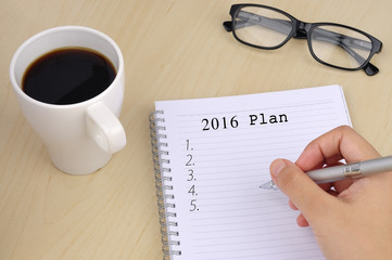 Hand Writing "2016 Target" on Notebook with Cup of Coffee and Sp