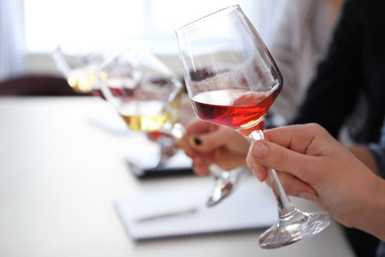 Experts tasting new sorts of wine at the table