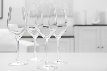 Wineglasses on blurred interior background