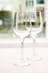 Wineglasses on blurred interior background