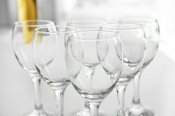 Wineglasses on blurred interior background