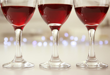 Glasses of red wine on white table closeup