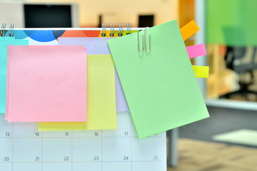 Colorful of sticky notes on calendar at business office with copy space for text.