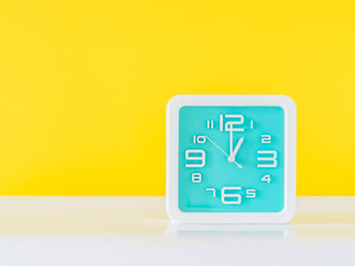 Clock and vivid yellow background.