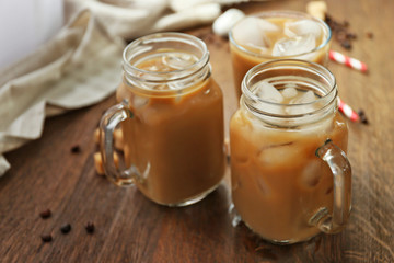 Iced coffee with milk on wooden table