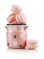 Tasty macaroons in cup, isolated on white