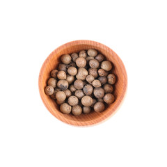 Aromatic allspice in small wooden bowl isolated on white