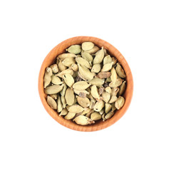 Cardamom seeds in small wooden bowl isolated on white