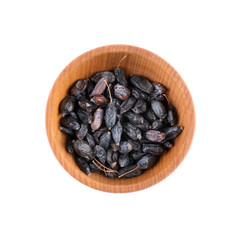 Dried barberry in small wooden bowl isolated on white
