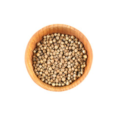 Coriander seeds in small wooden bowl isolated on white