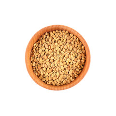 Fenugreek seeds in small wooden bowl isolated on white