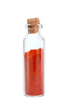 Powdered paprika in glass bottle on white background
