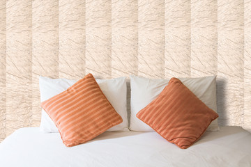 white pillow and orange pillow on bed and with blanket in vintag