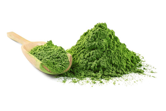 Fototapeta Wooden spoon with powdered matcha green tea, isolated on white